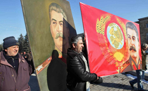 Georgian Communist Party members carry portraits of Stalin during a march on December 21, 2013 in hi