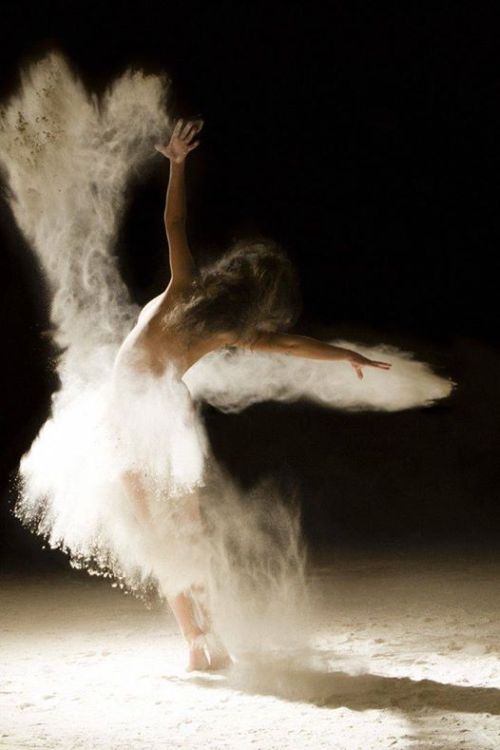 A photo of a dancer with flour to emphasize her movement.