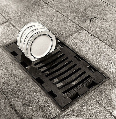sqbr:  [Black and white photos: A woman stands behind a dark filled martina glass that looks kind of like pubic hair/thigh gap; plates in a drain as if it was a dish rack; A smoker in front of a white road that looks like smoke from their ciggarette;