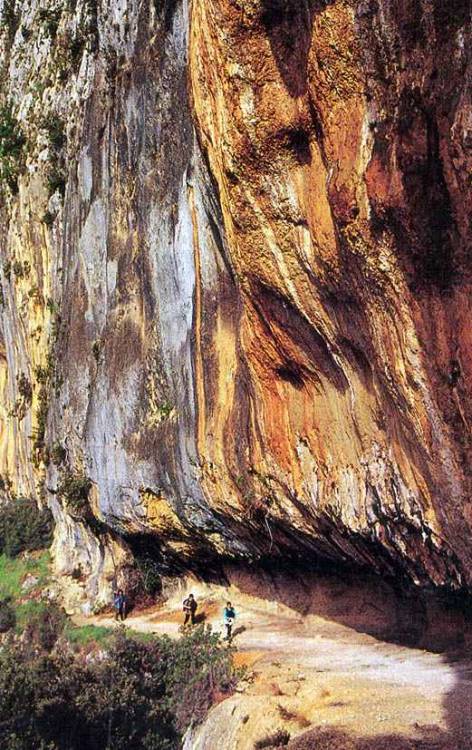 Mineral-stained limestone cliffs in the Gorges de l'Ardèche insouthern France.  The path leads diago