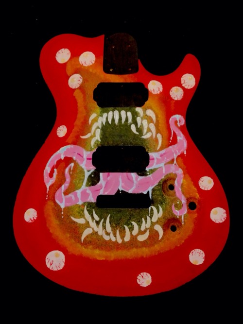 show-some-teeth:I painted this guitar that my uncle made. The eyes and teeth glow in the dark.