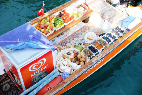 Beautiful boat full of fresh figs, grapes, fresh baked pastries with powdered sugar, vegetables, melon and nuts. 