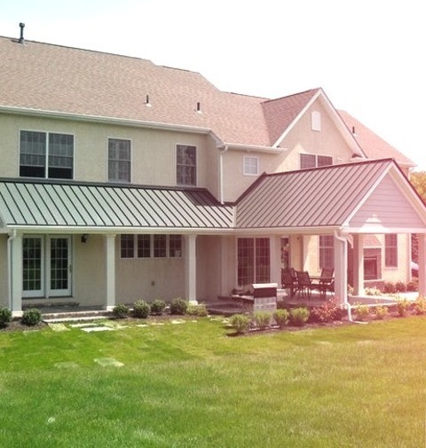 Traditional Patio - Roof ExtensionsLarge Elegant Backyard Stone Patio Photo With A Roof Extension