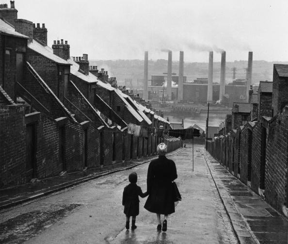 Bert Hardy. Newcastle Street. A woman and child walking down a Tyneside street, in Newcastle, England, 1950. From Bert Hardy/Getty Images