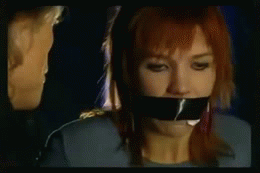 sittightbondage:  A very cute red haired Dutch damsel is captured by a leather clad villain type, and begins to talk back to him, probably saying things like “you won’t get away with this, they will find me” bla bla bla trying to threaten him. He