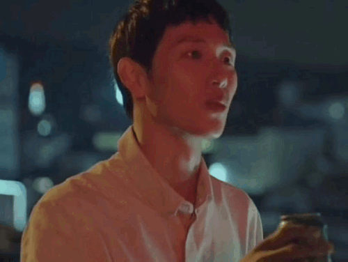 Jongwoo gasping and leaning back, holding up the can.