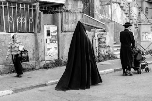 Jewish woman in Mea Shearim market. Jerusalem, 2012.The pointed headgear aimed to conceal completely