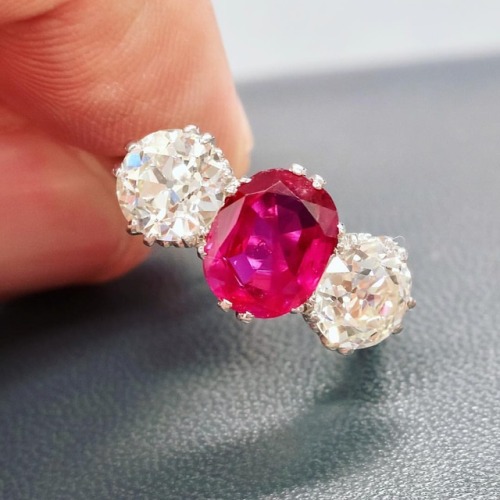 This Three-Stone Ring is set with a beautiful Burmese ruby between a pair of old European-cut diamon