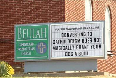 Two churches located across the street from each other.  At least the Catholics have a sense of humor.