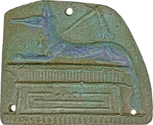 Ancient Egyptian funerary amulet in the shape of a plaque, depicting a jackal, representing Anubis, 