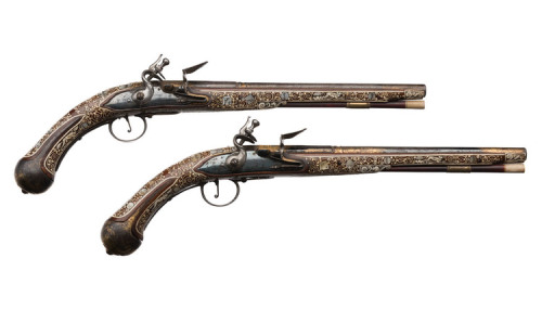 A pair of ornate flintlock pistols originating from Silesia, 19th century.