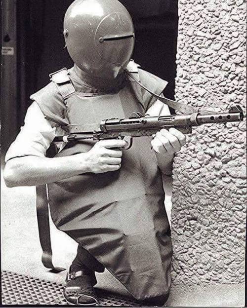 colonel-kurtz-official:A Swedish police officer equipped with experimental body armor and the Carl G