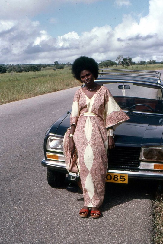 forafricans: A woman poses for a portrait by a roadside. Mikumi National Park, Tanzania. 1980.  