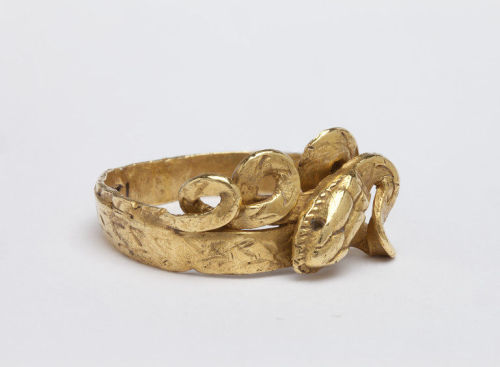 ancientjewels:Roman 1st Century CE gold ring in the form of a snake, formerly with inset stones. Fro