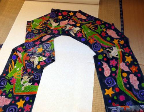 Colorful modern chirimen obi, depicting kids gleefully playing alongside joyful dragons.Happy kodomo