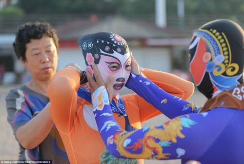 Chinese women model the sixth-generation facekini designs on a beach in Qingdao City, in China&r