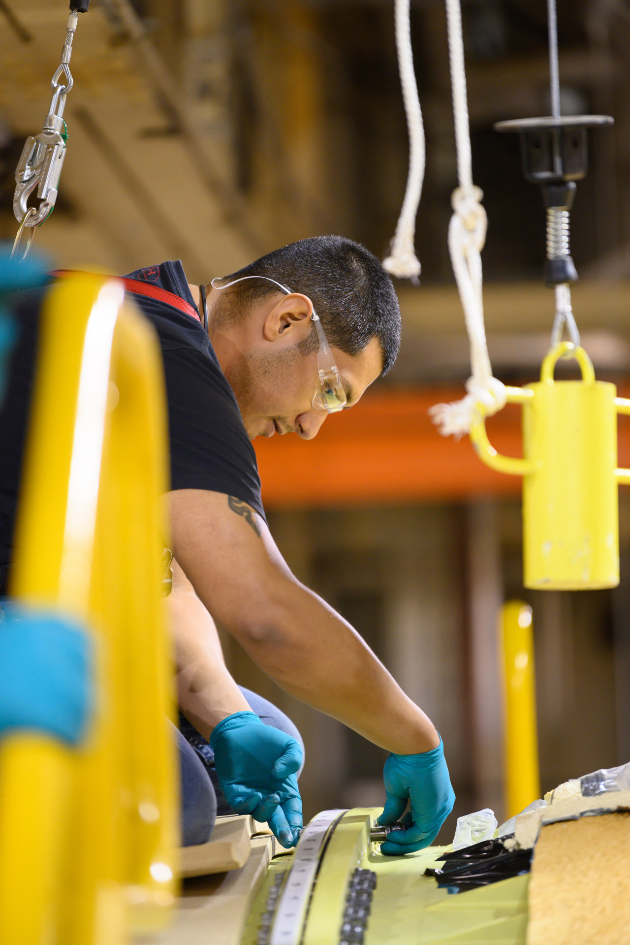 A technician at NASA’s Michoud Assembly Facility fastens a bolt to the core stage for the SLS rocket.