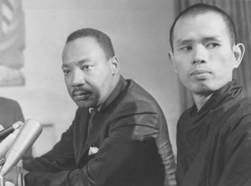 [Photo: Martin Luther King, Jr. and Thich Nhat Hanh sit together in front of a set of microphones. B