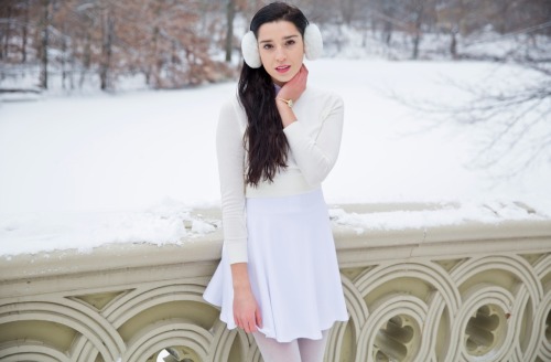 americanapparel:  Alanna in a winter wonderland wearing the Poplin Round Collar Short Sleeve Button-Up in White, Ponte Sleeveless Skater Dress in White, the Unisex Earmuffs in White, the Lightweight Crop Sweater in Creme and the Sparkle Pantyhose in White