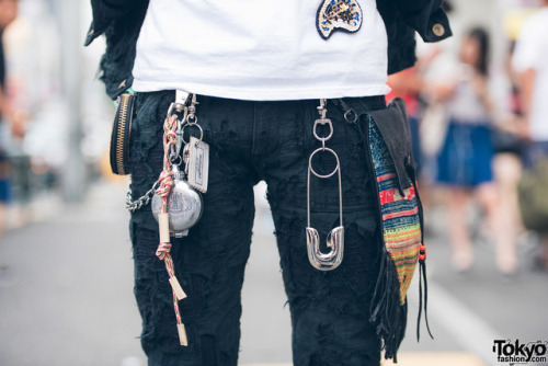 Japanese high school student Nashu on the street in Harajuku wearing a distressed denim jacket and m