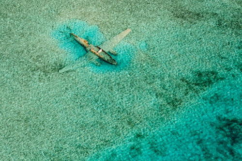 destroyed-and-abandoned:  Crashed Curtiss C-46 aircraft near Norman’s Cay, Exumas, Bahamas  photo by Bjorn Moerman soupyhands:source 