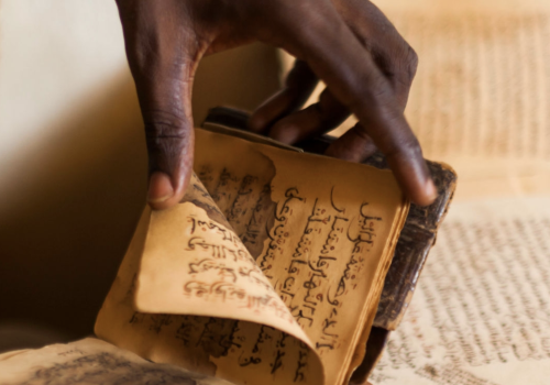 Malian copyist Boubacar Sadeck consults an ancient manuscript on July 29, 2013 in Bamako, Mali.> 