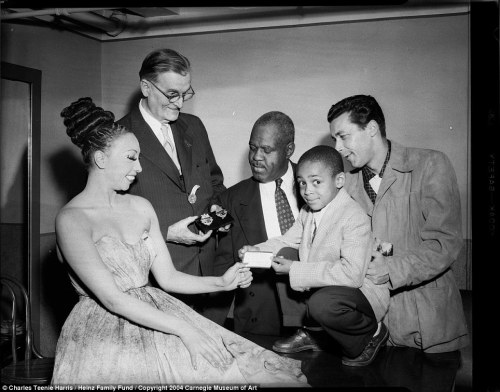 Josephine Baker accepting a Hill City membership card from Leslie Powell, with George Fairley holdin