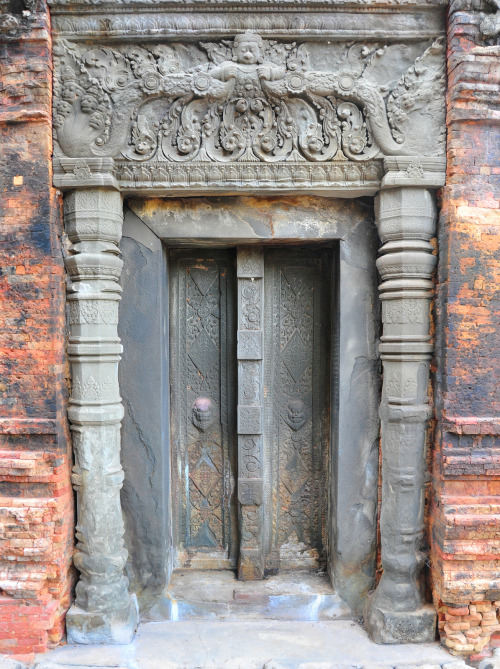 A false door on one of the Preah Ko towers, Cambodia. Writing is chiseled into the tower doorways, a