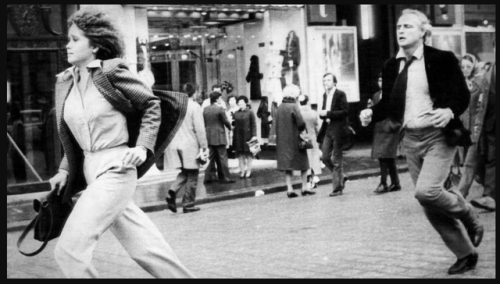 A woman running from a man. (Maria Schneider and Marlon Brando in Last Tango In Paris (1972, directe