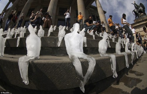 sixpenceee:  A thousand miniature people have slowly melted away in a Berlin square in an effort to draw attention to melting ice caps in Greenland and Antarctica. Brazilian artist Nele Azevedo carved the figures out of ice and placed them on steps in