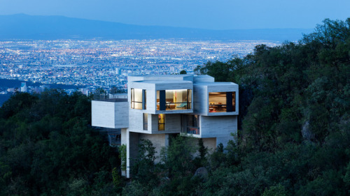 archatlas:  Ventura House in MonterreyThis house by Mexican architect Tatiana Bilbao comprises a cluster of five-sided concrete blocks that emerge from a forested hillside to offer panoramic views towards the city of Monterrey. The uneven terrain informed