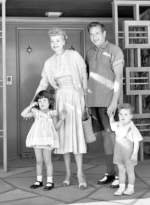 Lucille Ball and Desi Arnaz photographed outside their home with their children, 1954