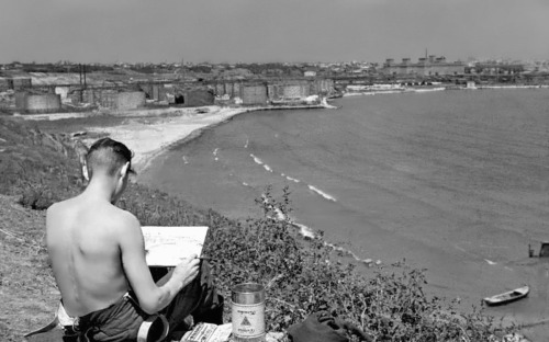 bag-of-dirt: A German soldier paints the Port of Constanța on a hill above the city. Roman