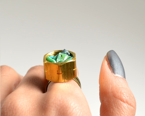 DIY Hardware Store Stone Chip RIng Tutorial from Studs and Pearls here. It looks like she uses resin