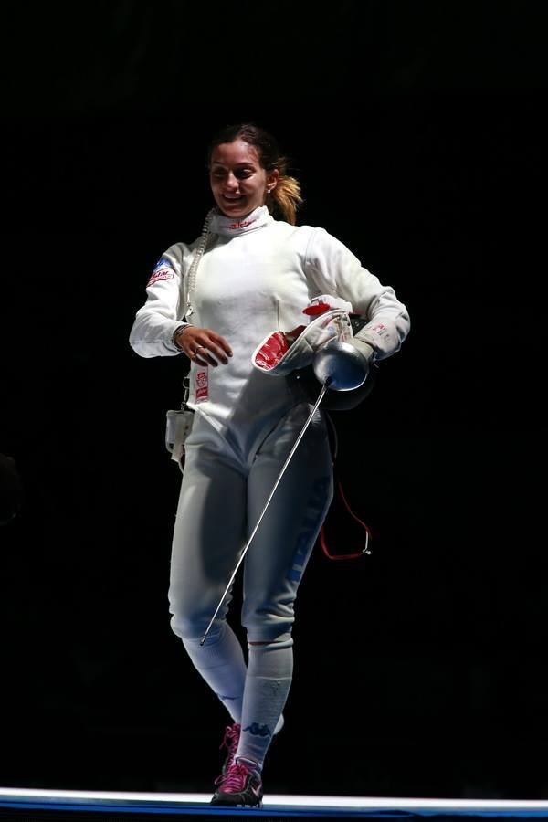modernfencing:  [ID: an epee fencer walking off strip and smiling.]Rossella Fiamingo,