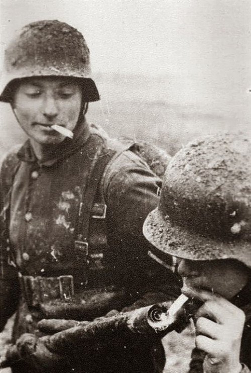German soldiers using a flamethrower to light a cigarette. Flamethrowers were used on the Eastern Fr
