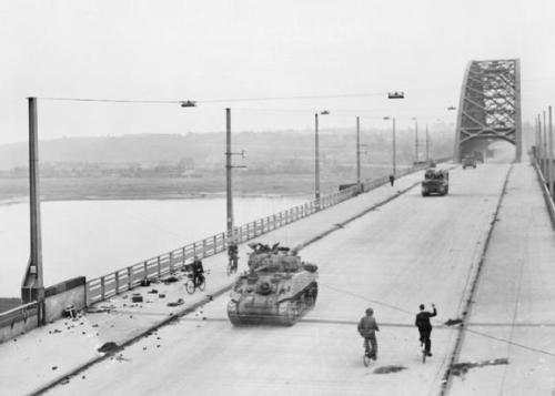 demons:Allied tanks of British XXX Corps cross the road bridge at Nijmegen during its capture/Septem