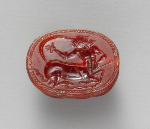 aleyma:Etruscan, Carnelian scarab with wounded centaur, c.450 BC (source).