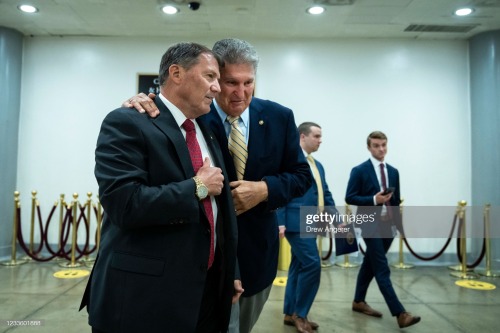 Sen. Mike Rounds (R-SD) walks with Sen. Joe Manchin (D-WV) as they head to a vote on some bill. I&rs