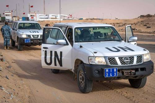 Vehicles of the United Nations Mission for the Referendum in Western Sahara (MINURSO) at a border cr