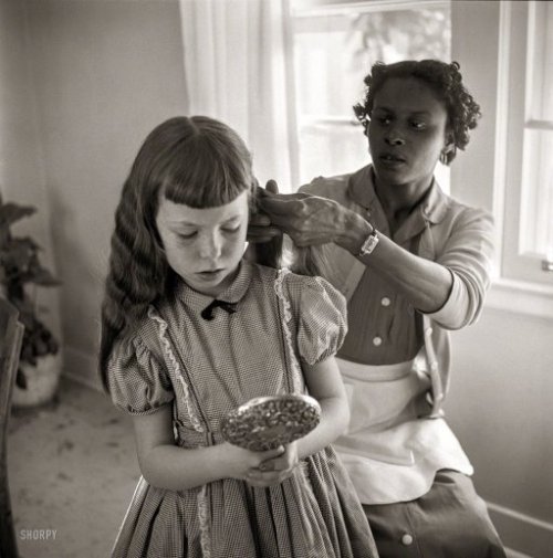 federer7:February 1956. “Domestic worker fixing girl’s hair.” From photos by Bern Keating for the Lo