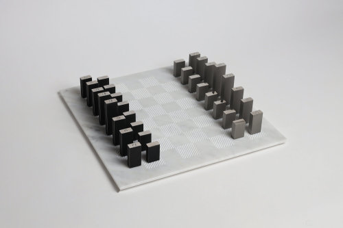 Tarek Elkassouf‘s chess setMaterial: Carrara marble board with Brushed Stainless Steel and Gun Metal