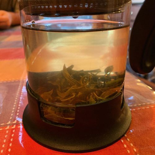 Trying an unusual tea called “green pearls of agni,” which is a smoked green tea that smells conside
