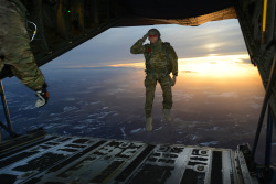 gunrunnerhell:  JumpA U.S. Soldier assigned to 1st Battalion, 10th Special Forces Group (Airborne) salutes his fellow Soldiers while  jumping out of a C-130 Hercules aircraft over a drop zone in Germany,  Feb. 24, 2015. (U.S. Army photo by Visual Informat