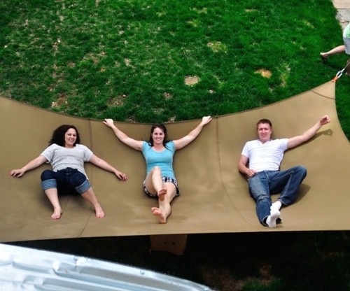 awesomeshityoucanbuy:  Mega HammockHost an orgy of relaxation in your backyard when you install the mega hammock! This gargantuan hammock – at what point is this not classified as a tarp? – is custom made out of a tough bonded nylon thread and is