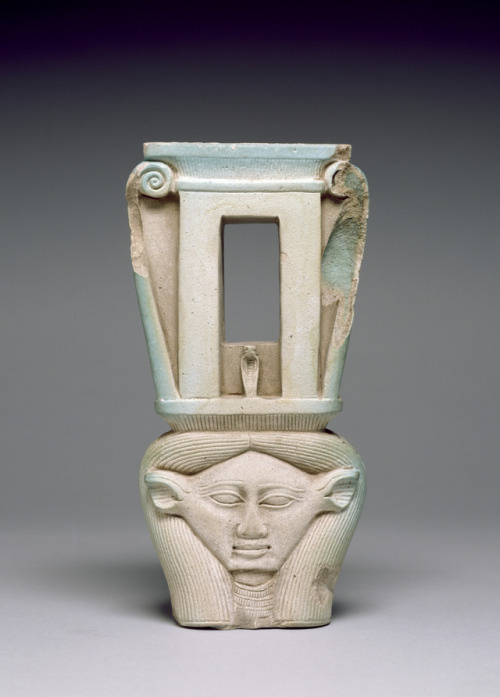 Ancient Egyptian sistrum (rattle) made of glazed faience, depicting the goddess Hathor topped by the