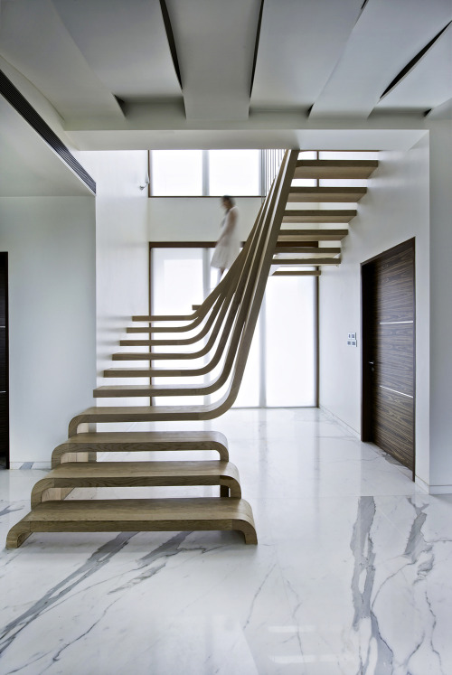 {The centerpiece of this apartment by Arquitectura En Movimiento Workshop is the staircase, a striki