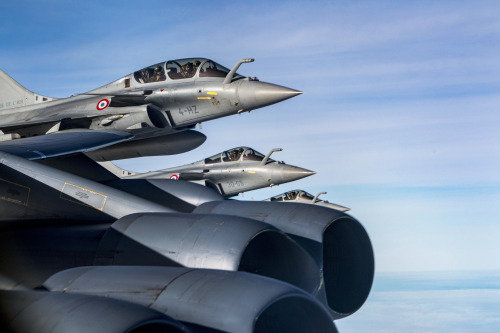 French Air Force Dassault Rafales assigned to La Fayette 2/4 Fighter Squadron fly next to the wing o