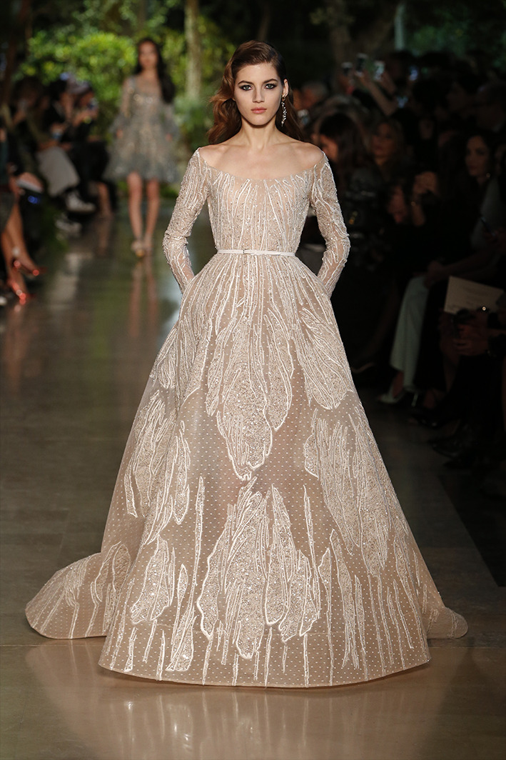 eliesaab:Ivory couture gowns dressed with lace and feathers, sequins and pearls.