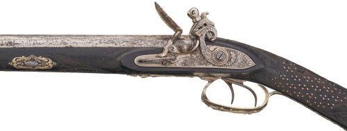 A double barrel flintlock shotgun with relief carved stock, maker and origin unknown, early 19th cen